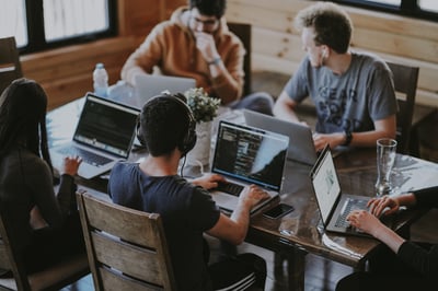 Group of people working together on laptops