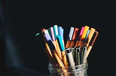 coloured pens in a jar